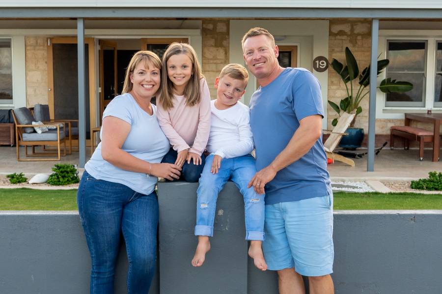 happy family in front of home